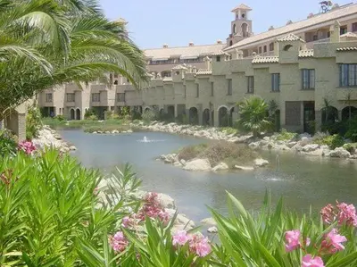 a large building with a river in front of it at Marina Sur in San Fernando