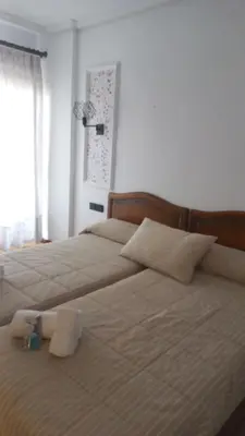 a bedroom with two beds and a window at Marina Sur in San Fernando