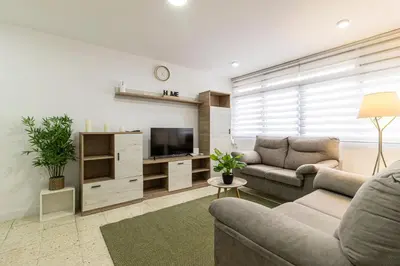 a living room with two couches and a flat screen tv at Sherry Sunset in Jerez de la Frontera