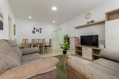 a living room with a couch and a flat screen tv at Sherry Sunset in Jerez de la Frontera