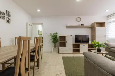 a kitchen and living room with a table and a television at Sherry Sunset in Jerez de la Frontera