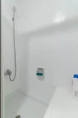 a bathroom with a shower with a scale on the wall at Sherry Sunset in Jerez de la Frontera