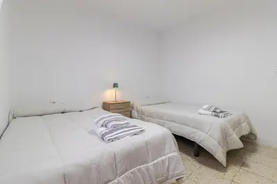 two beds sitting next to each other in a bedroom at Sherry Sunset in Jerez de la Frontera
