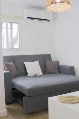 a living room with a couch and a coffee table at Rinconcito Sanlucar de Barrameda in Sanlúcar de Barrameda
