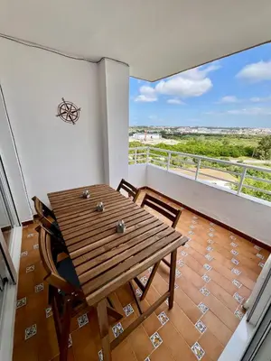a dining room with a wooden table and a balcony at GATU Náutico 