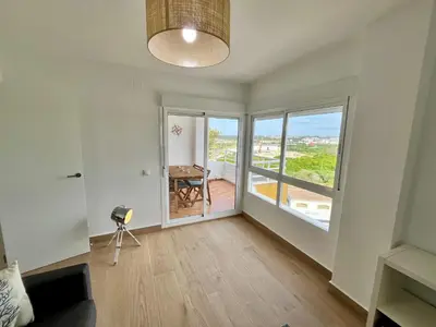 a living room with a table and a large window at GATU Náutico 