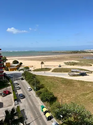 a road with cars parked on the beach at GATU Náutico 