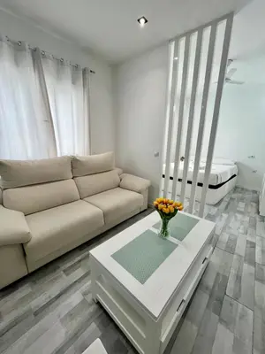 a living room with a couch and a table at GATU Alquiladores 