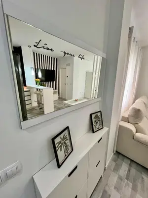 a mirror on a wall above a dresser in a room at GATU Alquiladores 