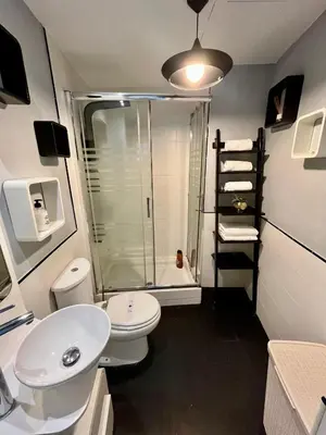 a bathroom with a shower and a toilet and a sink at GATU Alquiladores 