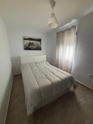 a bedroom with a bed in a white room at Las Manuelas in Arcos de la Frontera