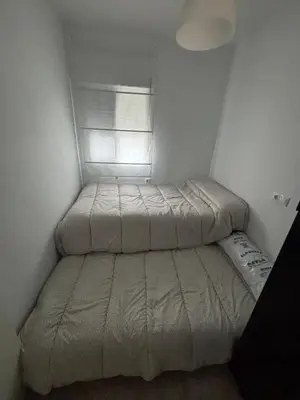 a small bedroom with a bed and a window at Las Manuelas in Arcos de la Frontera