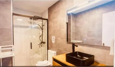 a bathroom with a black sink and a shower at Alma gaditana en la caleta in Cádiz