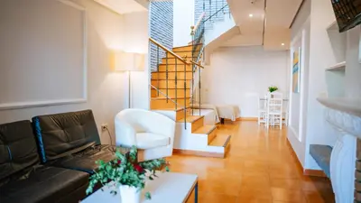 a living room with a couch and a staircase at Bungalows Bahia Sur in San Fernando