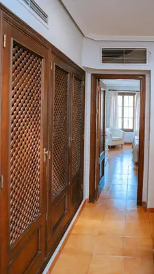 a hallway with wooden cabinets and a living room at Bungalows Bahia Sur in San Fernando