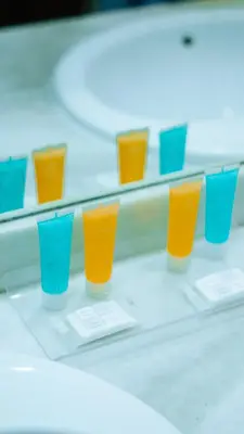 a row of orange and blue glasses on a shelf at Bungalows Bahia Sur in San Fernando