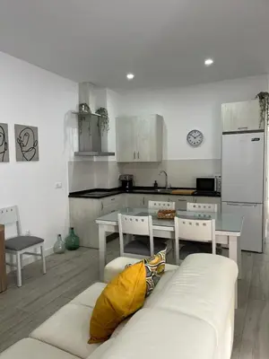 a kitchen with a couch and a table in a room at Austria 05 in Lebrija