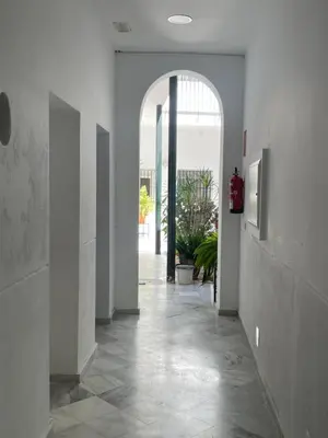 a hallway with an archway in a building at Jardines de Santa María - Parking gratis in Jerez de la Frontera
