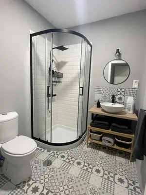 a bathroom with a shower and a toilet and a sink at Jardines de Santa María - Parking gratis in Jerez de la Frontera