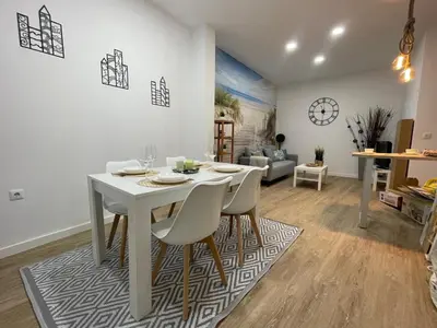 a white table and chairs in a living room at Jardines de Santa María - Parking gratis in Jerez de la Frontera