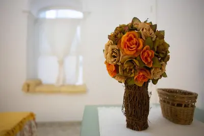 a vase with a bouquet of flowers on a table at Alojamientos Cadiz Sol in Cádiz