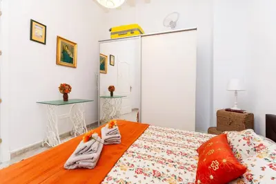 a bedroom with a bed with towels on it at Alojamientos Cadiz Sol in Cádiz