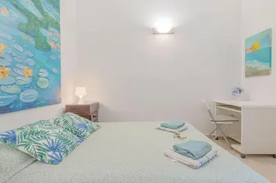 a bedroom with a bed with towels on it at Alojamientos Cadiz Sol in Cádiz