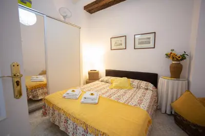 a small bedroom with two beds and a mirror at Alojamientos Cadiz Sol in Cádiz