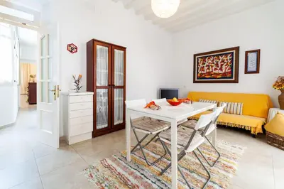 a living room with a table and a couch at Alojamientos Cadiz Sol in Cádiz