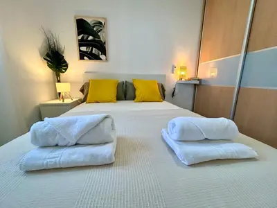 a bedroom with two white towels on a bed at GATU Villa Serena piscina privada mayores de 25 años y familias in Chiclana de la Frontera