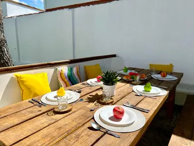 a wooden table with plates of food on it at GATU Villa Serena piscina privada mayores de 25 años y familias in Chiclana de la Frontera