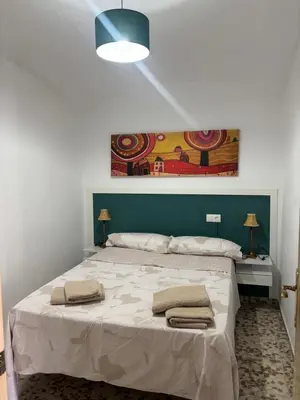 a bedroom with a large bed with two towels on it at Casita de Don Juan Tenorio in Torrecera