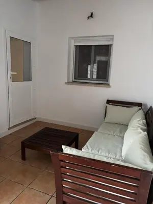 a couch and a table in a room with a window at Casita de Don Juan Tenorio in Torrecera