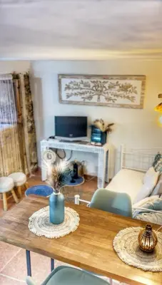 a living room with a table and a couch at Casa arabe in Alcalá de los Gazules