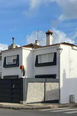a white house with a gate and a fence at Jerez Deluxe in Jerez de la Frontera