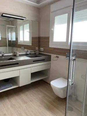 a bathroom with a sink and a toilet and a mirror at Jerez Deluxe in Jerez de la Frontera