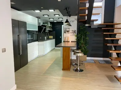 a kitchen with a island in the middle of a room at Jerez Deluxe in Jerez de la Frontera