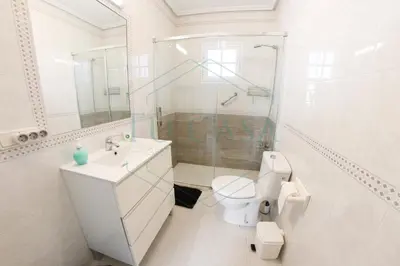 a bathroom with a toilet and a sink and a shower at Villa La Marea in Chiclana de la Frontera