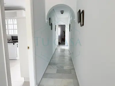 a hallway with an archway in a house at Villa La Marea in Chiclana de la Frontera