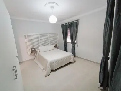 a bedroom with a white bed and a window at Apartamento B&A in El Cuervo
