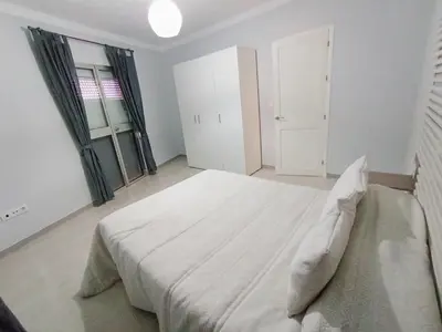 a white bedroom with a large white bed in it at Apartamento B&A in El Cuervo