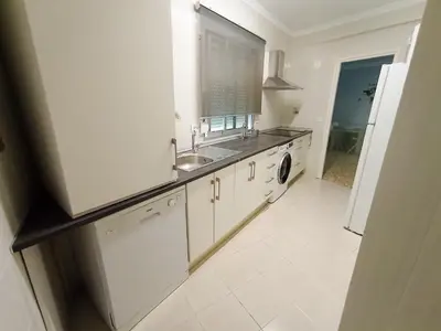 a white kitchen with a sink and a dishwasher at Apartamento B&A in El Cuervo
