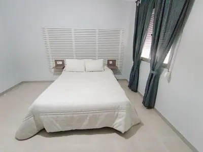 a white bed in a room with a window at Apartamento B&A in El Cuervo