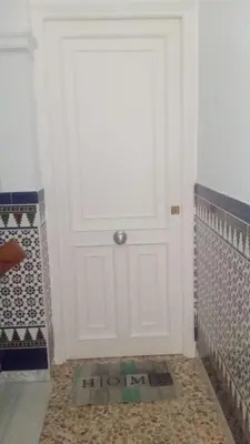 a white door in a room with a tile floor at Apartamento B&A in El Cuervo