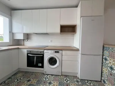 a kitchen with white cabinets and a washing machine at Apartamento Sanlúcar PARKING GRATIS ,PISCINA ,WIFI ATICO con vistas in Sanlúcar de Barrameda