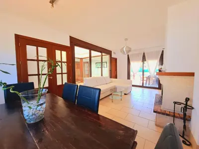 a living room with a table and a couch at Chalet Loma de Sanctipetri in Chiclana de la Frontera