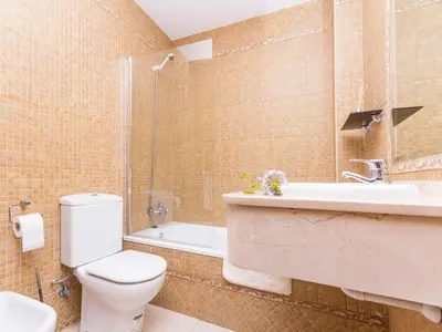 a bathroom with a toilet and a sink and a shower at Chalet Loma de Sanctipetri in Chiclana de la Frontera