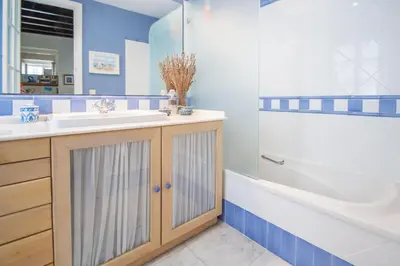 a bathroom with a sink and a tub and a toilet at La Casa de los Girasoles in Cádiz