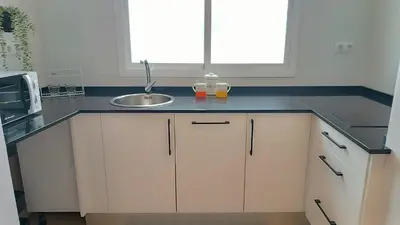 a kitchen with white cabinets and a stove top oven at Sherryflat Prieta 7 in Jerez de la Frontera