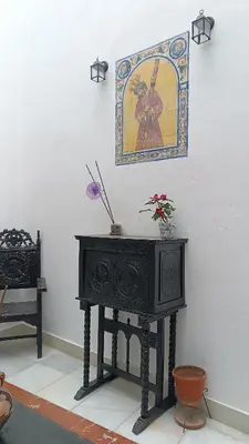 a room with a table and some chairs and windows at Sherryflat Prieta 7 in Jerez de la Frontera
